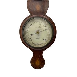A compact Edwardian Aneroid barometer in a  Regency “Sheraton style”case, broken pediment with finial and rounded base, mahogany veneered with satinwood stringing to the edge and panels of coloured and shaded conch shell and leaf inlay enclosed within entwined leaves, with a six inch dial recording barometric air pressure from 28 to 31 inches in fifths of an inch, steel indicating hand and brass recording hand, dial inscribed “J Casartelli & Son, 43 Market Street, Manchester”, with a flat bevelled glass and brass bezel, glazed arched topped thermometer box with a spirit thermometer and silvered register recording the temperature in degrees Fahrenheit.
*J Carsatelli & Son (1896-1925) A partnership between Joseph Lewis and his son Joseph Henry. The elder Joseph died in 1900 and the son carried on the business until his death in 1925.  
