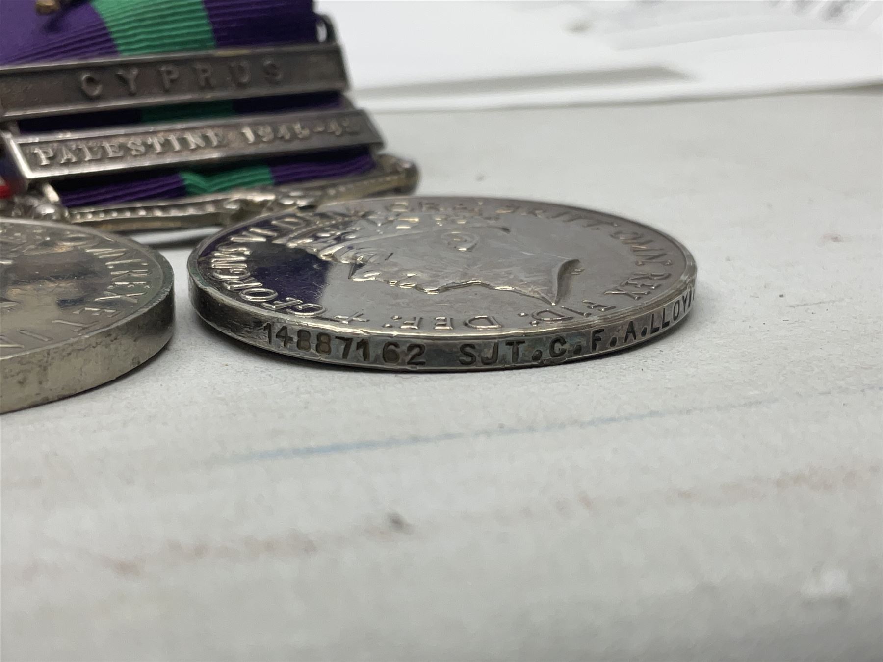 George VI General Service Medal with two clasps for Palestine 1945-48 and Cyprus and MID oak leaf awarded to 14887162 Sjt. C.F.A. Lloyd R.A.M.C. together with WW2 War Medal 1939-1945; both with ribbons; and quantity of photocopied research material including Army Records and London Gazette