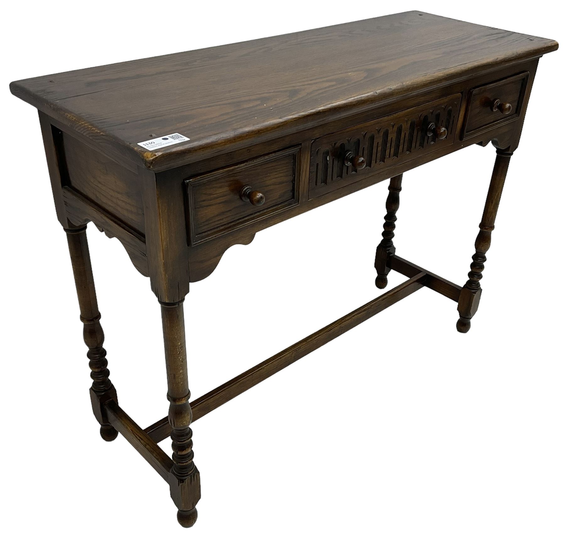 Medium oak side table, rectangular top over three drawers, on turned supports united by H-shaped stretcher rails 