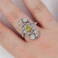 Early 20th century platinum diamond swirl ring, the principal old cut fancy yellow diamond of approx 0.50 carat, surrounded by old cut and single cut diamonds, in a milgrain pierced foliate design setting, total diamond weight approx 1.25 carat, with GCS certificate