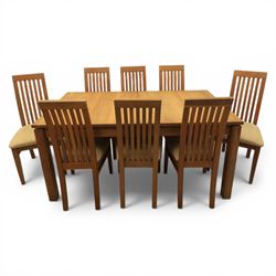 Contemporary teak dining suite comprising extending table and eight chairs, the table with...