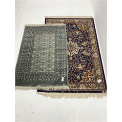 Shiraz blue ground rug, central medallion, repeating border (180cm x 120cm) and Bokhara green ground rug (146cm x 99cm)