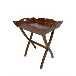Mahogany tray on butler's stand, the tray with shaped sides with pierced handles, on folding stand