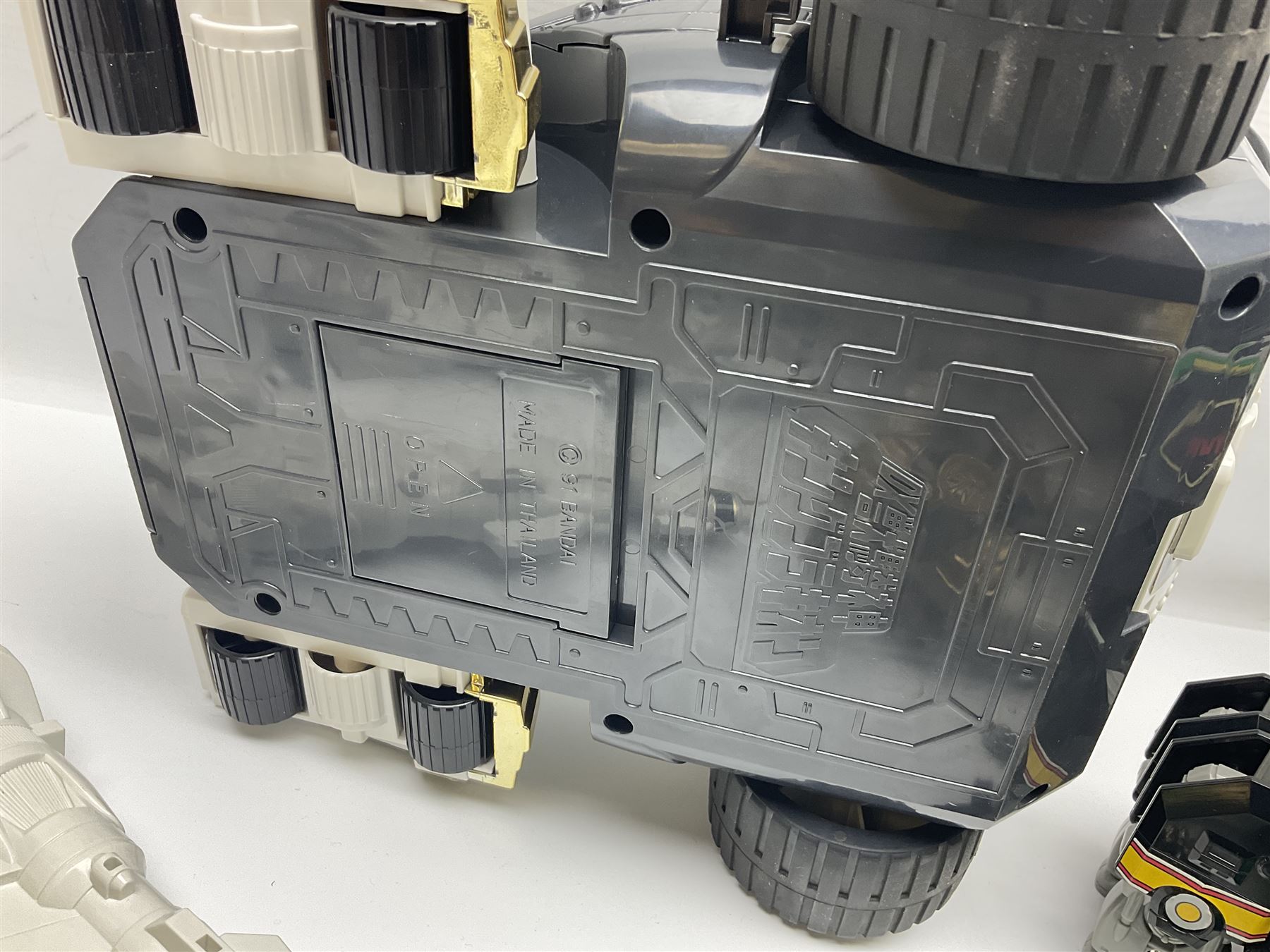 Collection of early 90s Mighty Morphin’ Power Rangers Zords, figures and accessories. Titanus the Carrier Zord, marked Bandai 1991; Green Dragonzord, incomplete; 1994 White Tigerzord with original instruction manual; 1993 Triceratops Dinozord, Mastodon Dinozord and Sabertooth Tiger Dinozord, Pterodactyl Dinozord, missing guns; with 1993 Power Morpher and original Power Coins, with further related figures, accessories and weapons