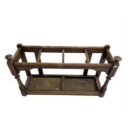 Edwardian oak hallway stick and umbrella stand, four divisions on turned supports, with metal tray liners and various sticks