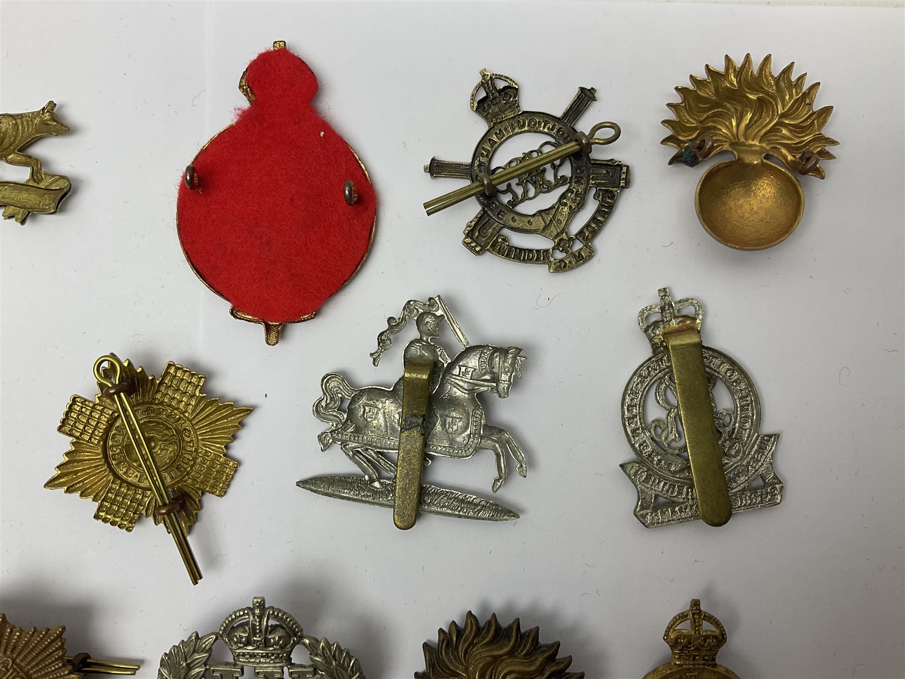 Twenty-six cap badges for Yeomanry and various guards including Fife & Forfar, Lothian and Border Horse, Leicestershire, Northamptonshire, Queens Own, Coldstream, Grenadier, Machine Gun Regiment, Life Guards etc (26)