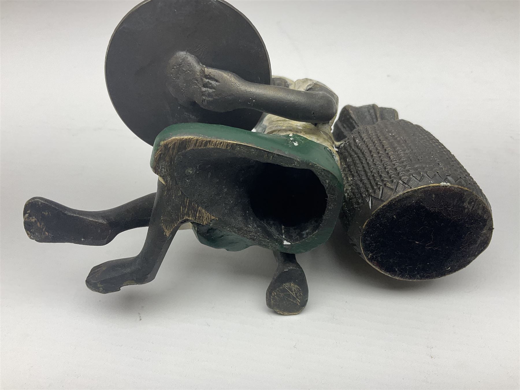 Bronze figure of a seated man resting on a sack