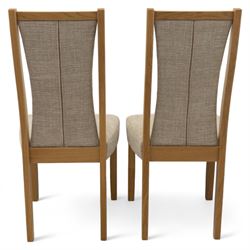 Ercol - light oak ‘Artisan’ rectangular dining table with chamfered top extending fold over top and tapered legs, together with two matching high back dining chairs upholstered in textured beige fabric (Chairs H 98cm, W 47cm, D 52cm)