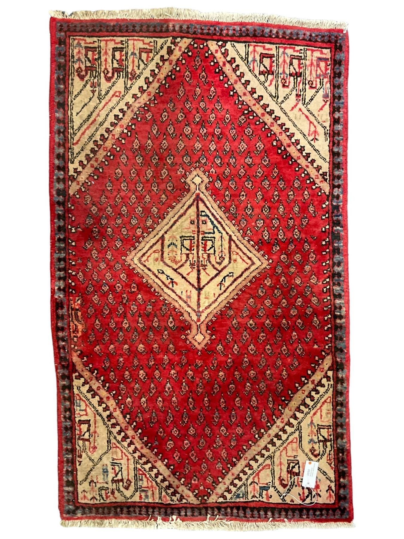 Small Persian red ground rug, lozenge medallion surrounded by small Boteh motifs