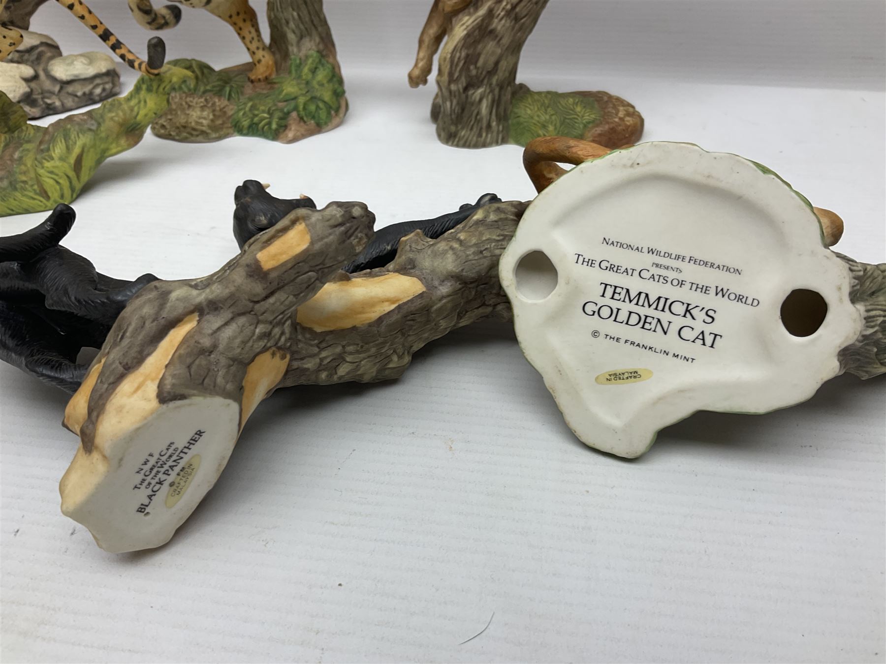 Ten Franklin Mint National wildlife Foundation Big Cats of the World figures to include, White Bengal Tiger, Jaguar, Cougar, Cheetah, Clouded Leopard etc, with display stand
