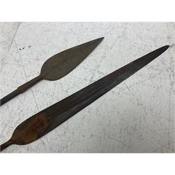 Native long-shafted spear, the large iron head with central medial ridge and decorative neck, on plain circular haft L260cm; and another similar Native long-shafted spear with cane haft L249cm (2)