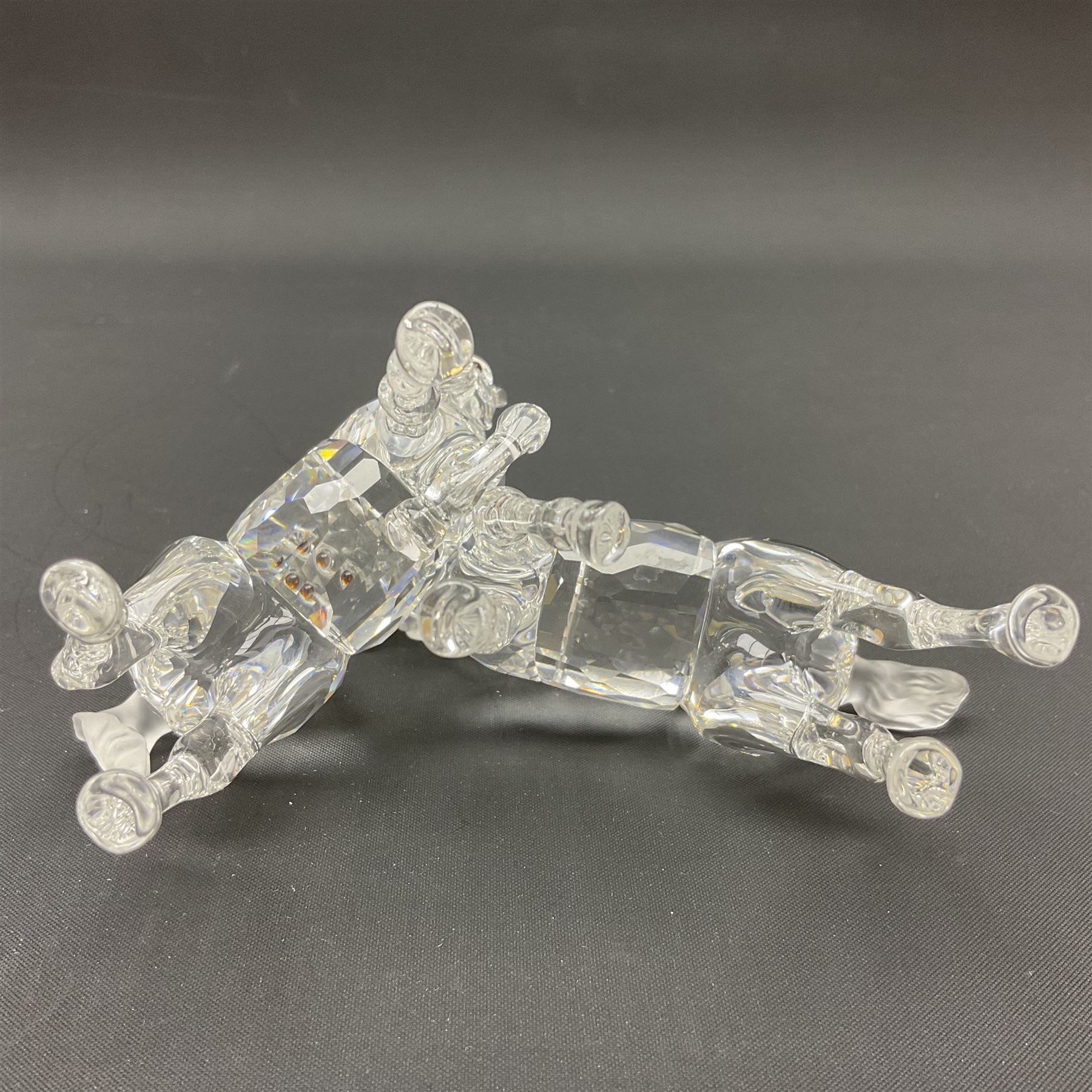 Five Swarovski Crystal horses, comprising stallion, rearing horse, pair of horses playing and Arabian stallion, each with frosted manes and tails, together with a small Swarovski Crystal galloping horse, the mane, tail and base with smoky tint