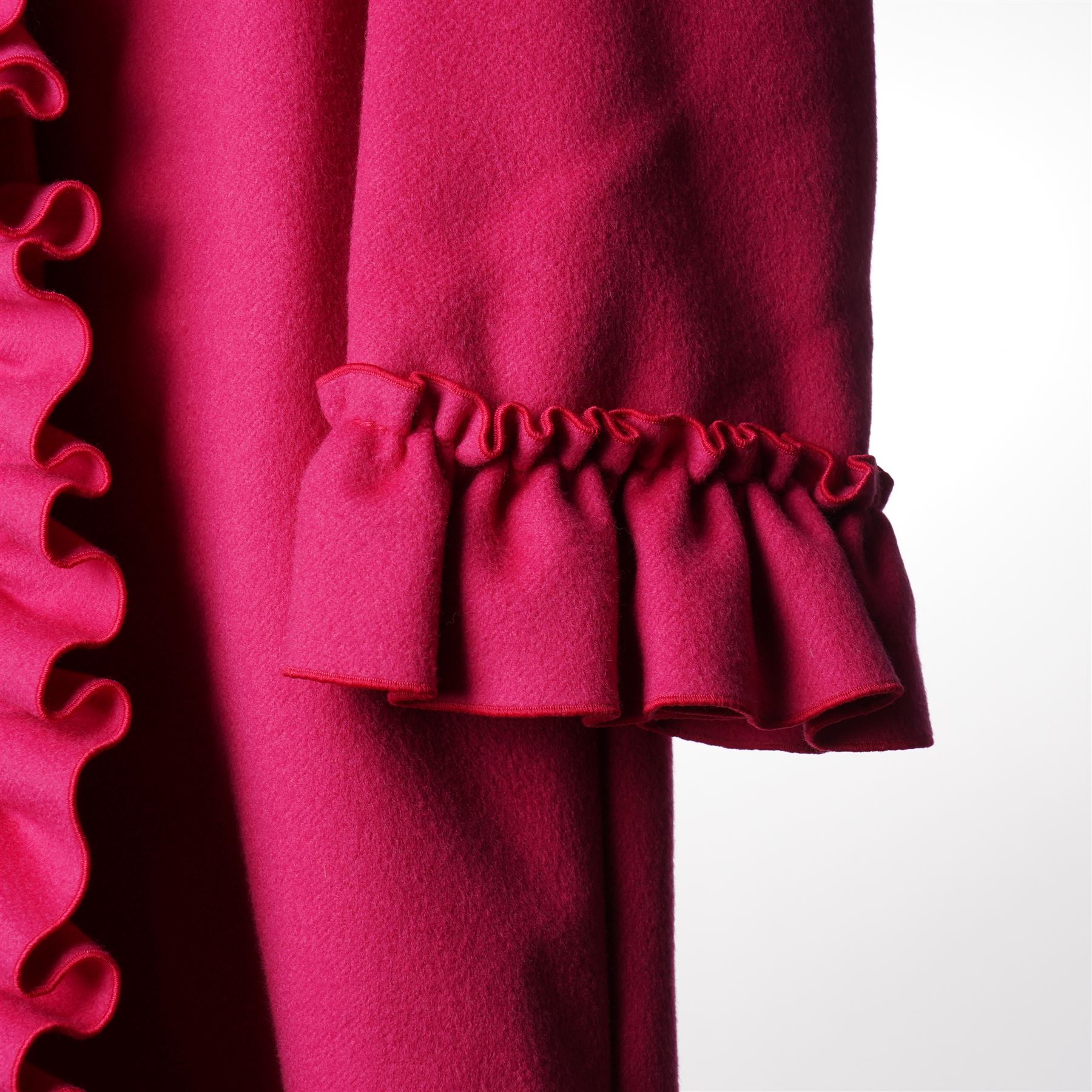 Gucci - wool ruffle-front single-breasted coat in bright fuchsia pink, with high ruffled collar, cascading ruffle trim to the front, collar and cuffs, faux pearl and gilt GG monogram logo button fastening, size 44, unused with the original garment bag and hanger