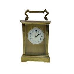 French - early 20th century 8-day brass carriage clock with a anglaise case and gilt dial surround, round enamel dial with blue Arabic numerals and steel spade hands, lever platform jewelled escapement. Movement backplate stamped R & Co Paris.
 