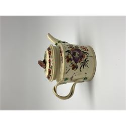 18th century creamware teapot, probably Leeds, with reeded entwined handle and floral finial to the cover, the body with hand painted polychrome decoration of figure to one side, and floral spray to the other, collectors paper label beneath inscribed Leeds Pottery, H11.5cm