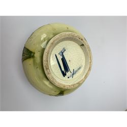 A Moorcroft vase, circa 1950, of squat bulbous form, decorated in the Orchid pattern upon a yellow glazed ground, with impressed and blue painted WM initials for Walter Moorcroft, H10.5cm. 