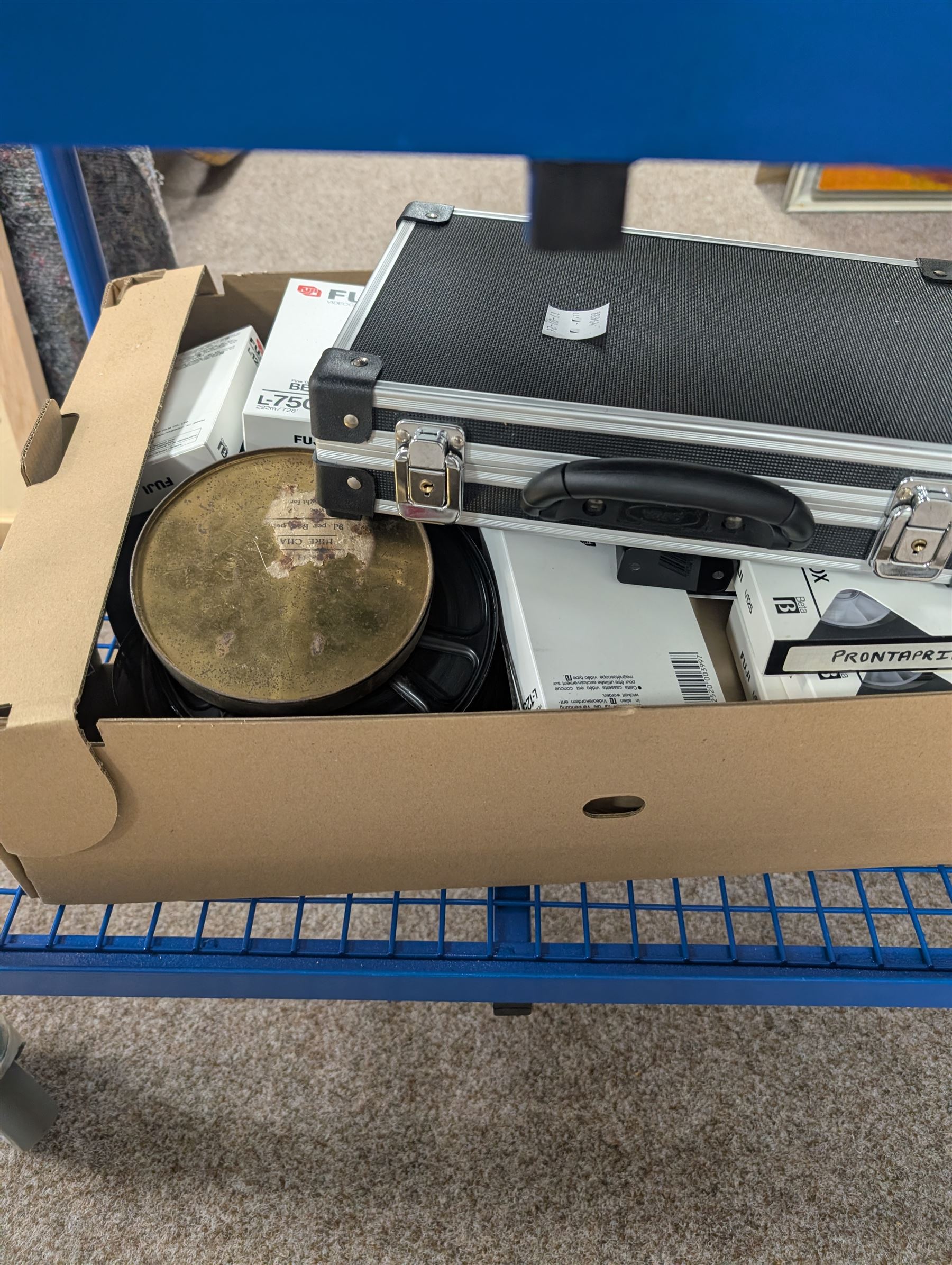 Collection of projectors, including Transpaque Junior overhead projector, Demo Comm 1 overhead projector, Bolex 18-9 Duo, Bolex 18-5, Pathescope Kid, Kodascope Model C, collection of video tapes and film reels, empty projector box, Kinay 816 editor, etc