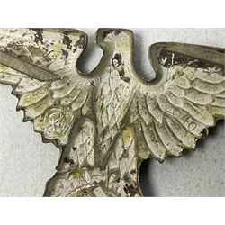 Two WW2 German 'SS' visor cap skull badges and another later; and visor cap eagle insignia (4)