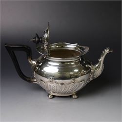 Edwardian silver three piece tea service, comprising teapot, twin handled open sucrier and a cream jug, each of oval form with embossed scrolling decoration and upon four bun feet, the teapot with ebonised wooden handle and finial, hallmarked Thomas Bradbury & Sons Ltd, Sheffield 1903, teapot H16cm