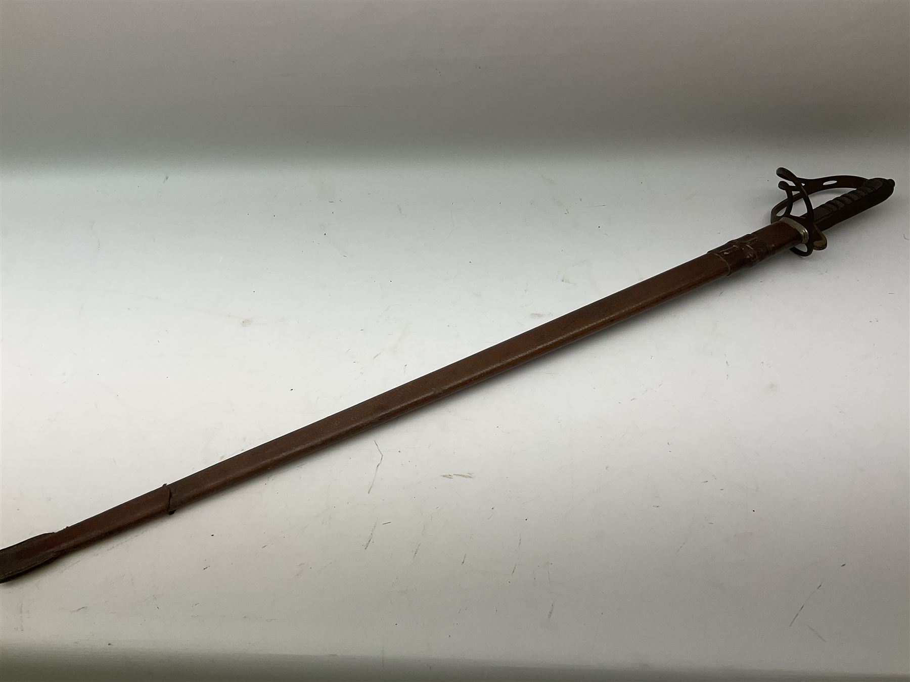 Victorian artillery officer's sword, the 90cm fullered steel blade by E. Thurkle Denmark Street Soho London decorated with Victoria cypher, Regimental crest and 'Royal Artillery', three-bar hilt with stepped pommel and wire-bound fish skin grip; in leather covered scabbard L107cm overall