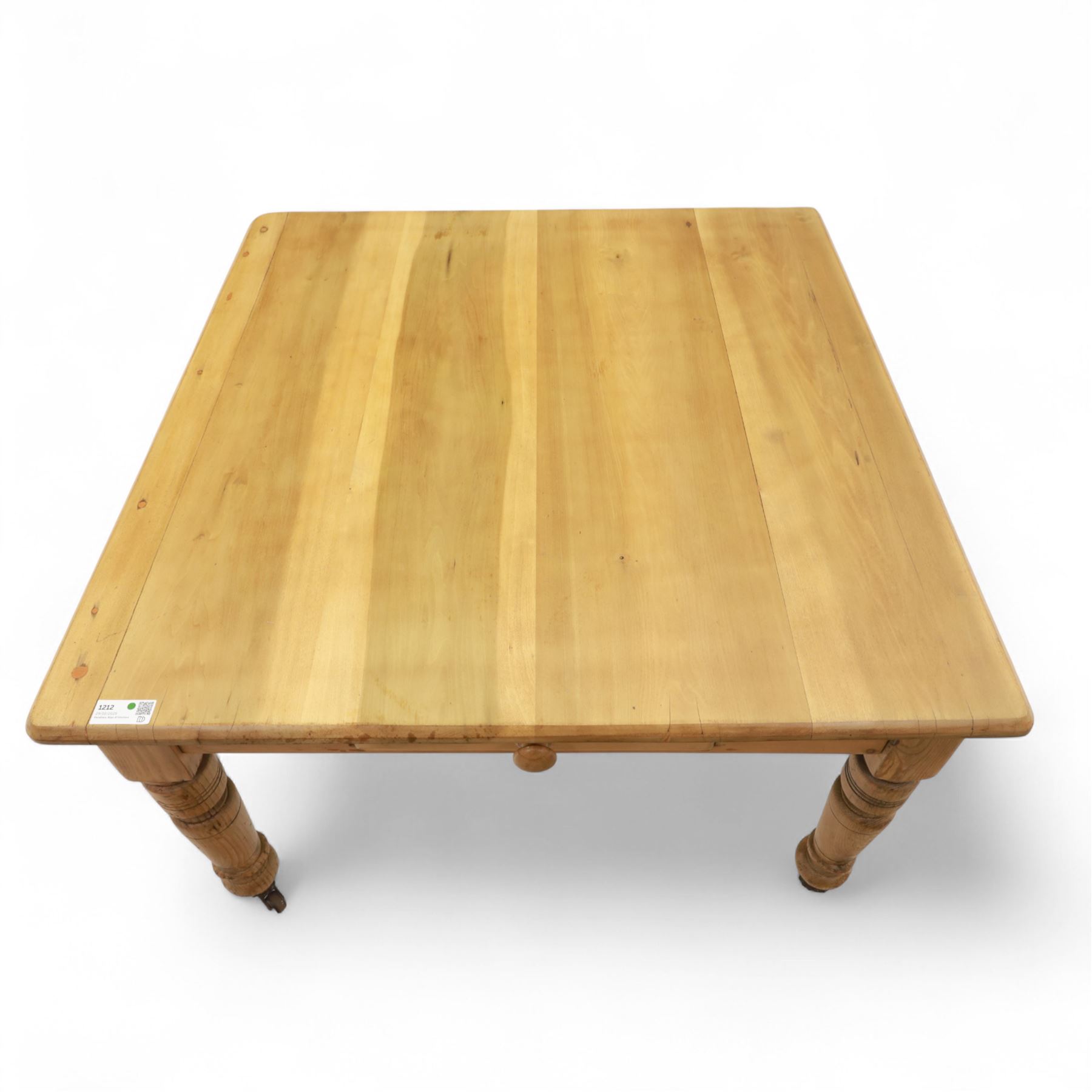 Contemporary pine kitchen table, rectangular top with moulded edge, fitted with single drawer, raised on turned supports with ceramic castors
