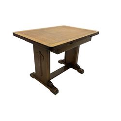Oak rectangular extending dining table, shaped end supports with foliate decoration, on sledge feet