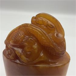 Chinese amber soapstone seal of oval form,  carved temple dog finial, inscription on the back and base, H12cm