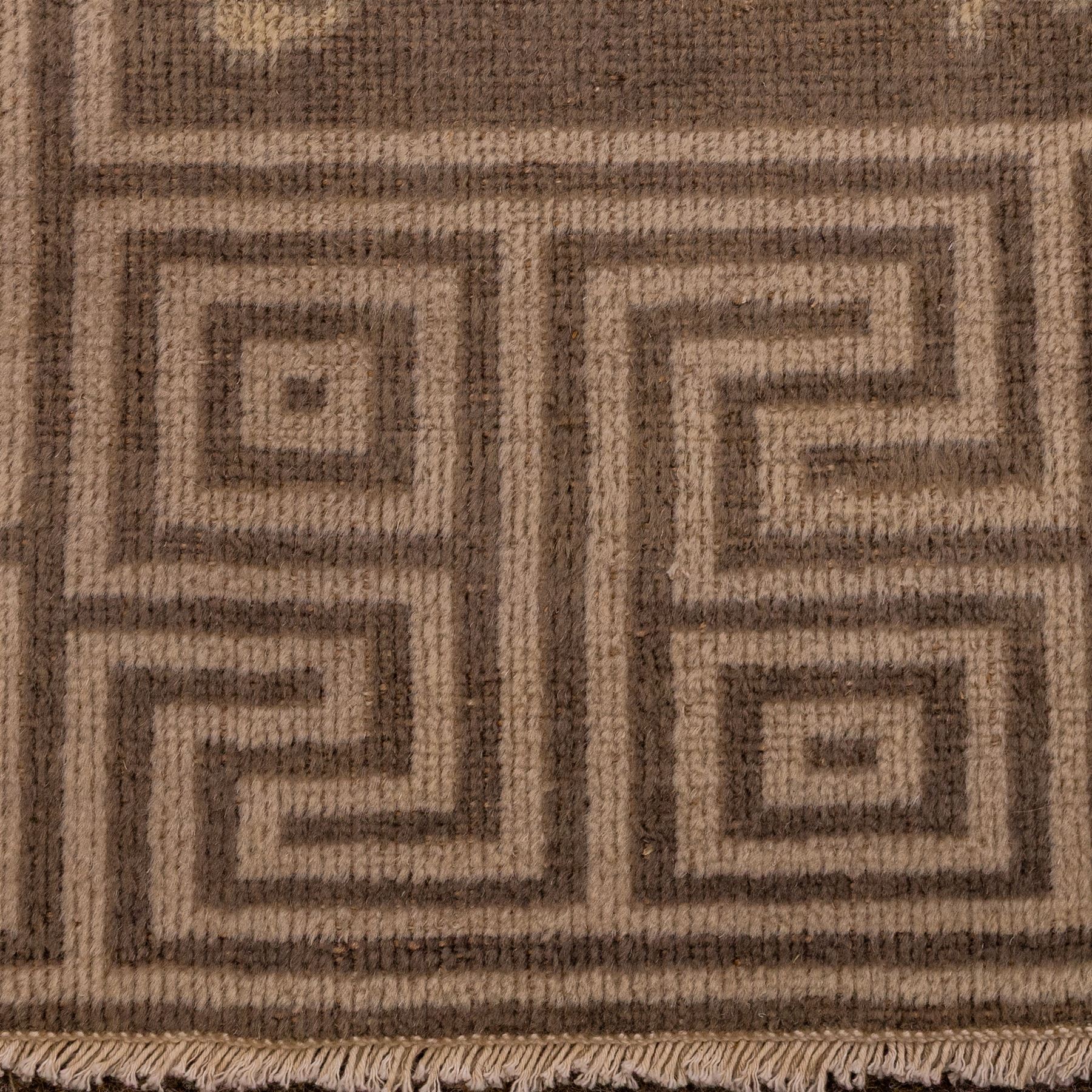 Indian Khetar hand knotted carpet, the brown ground decorated with an all over scrolling foliate and palmette design, enclosed within a conforming floral border with guard stripes