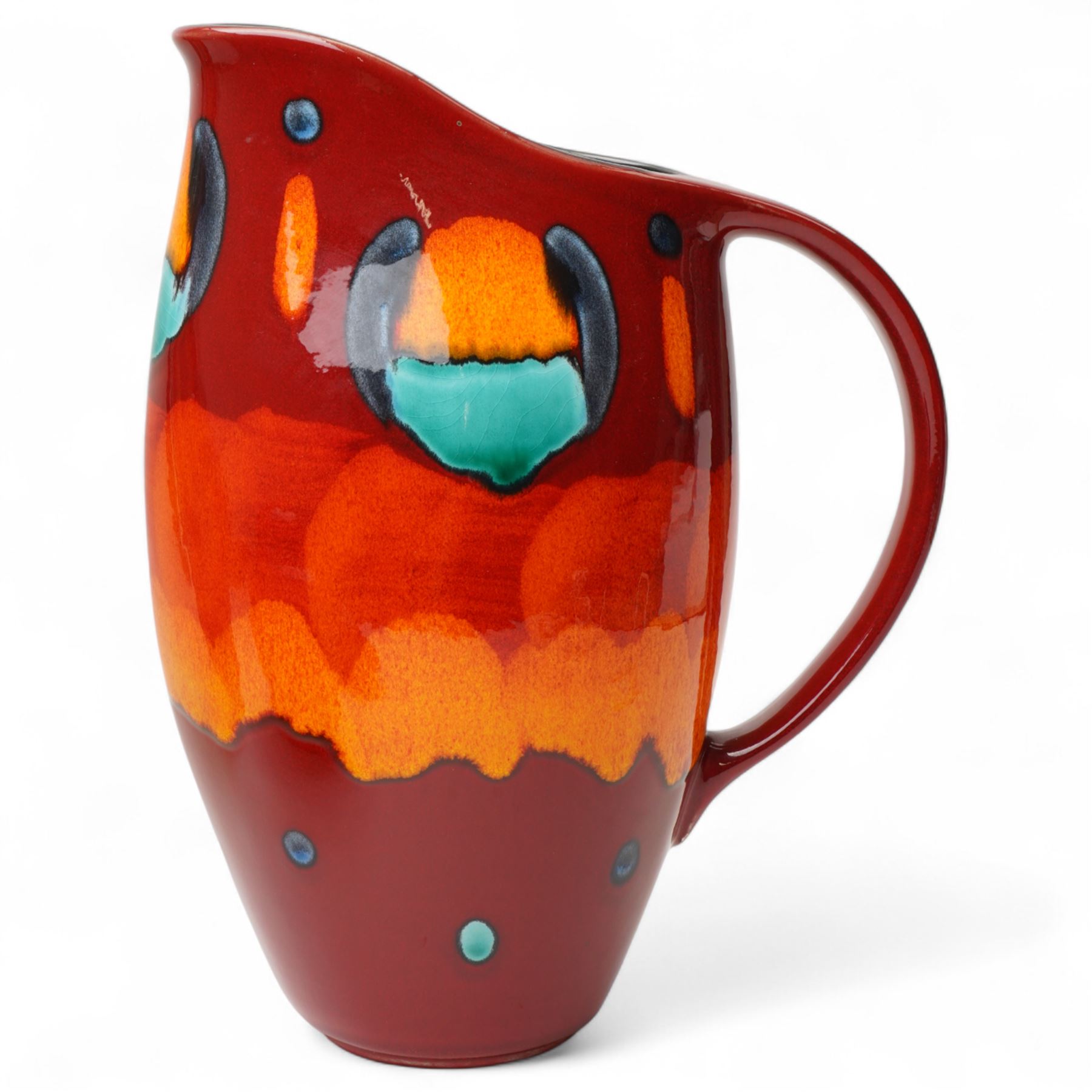 Four Poole pottery 'Volcano' pattern items comprising charger