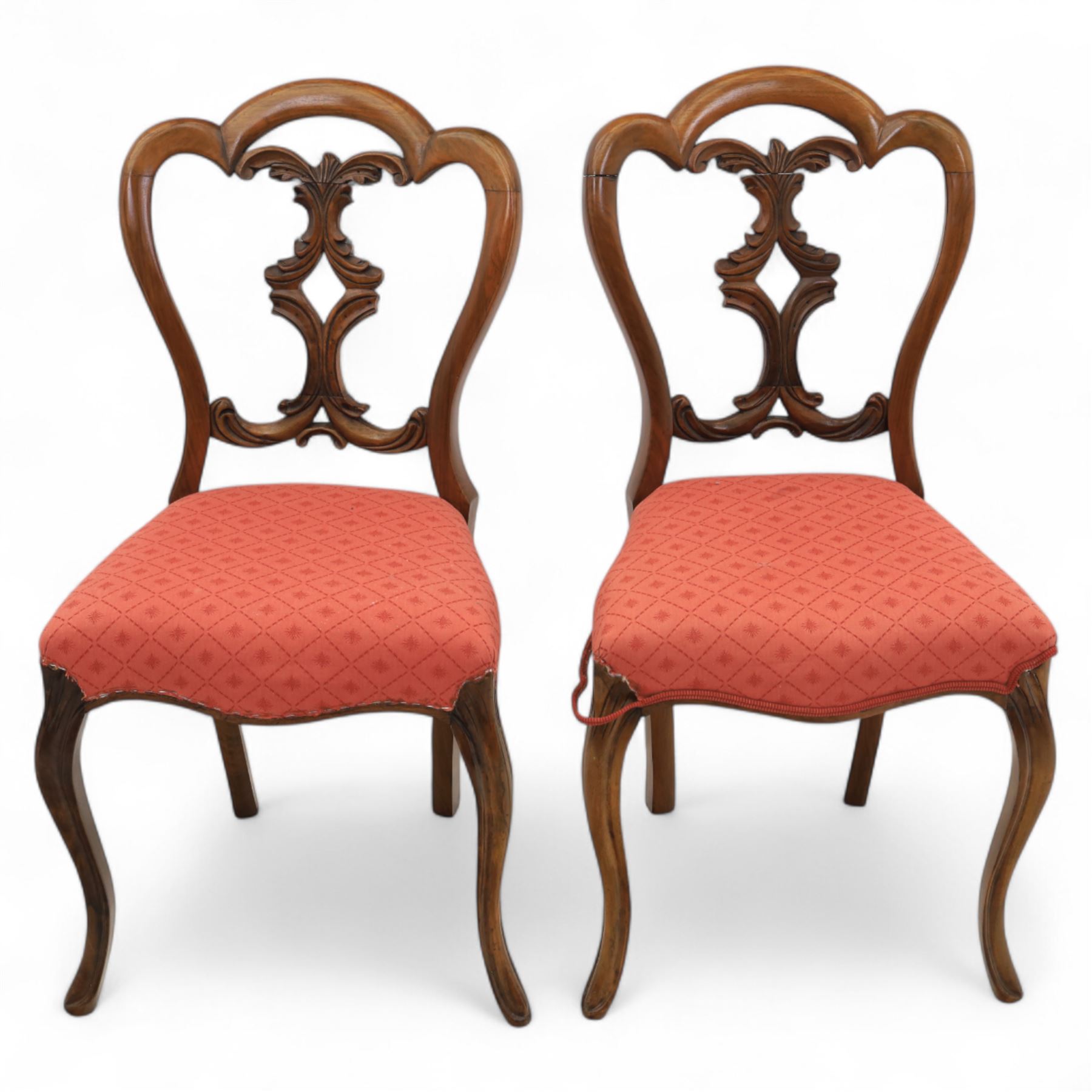 Set of four Victorian walnut balloon back chairs, with a carved and pierced back splat with foliate scrolls, serpentine seat upholstered in a diamond pattern fabric, raised on cabriole legs 