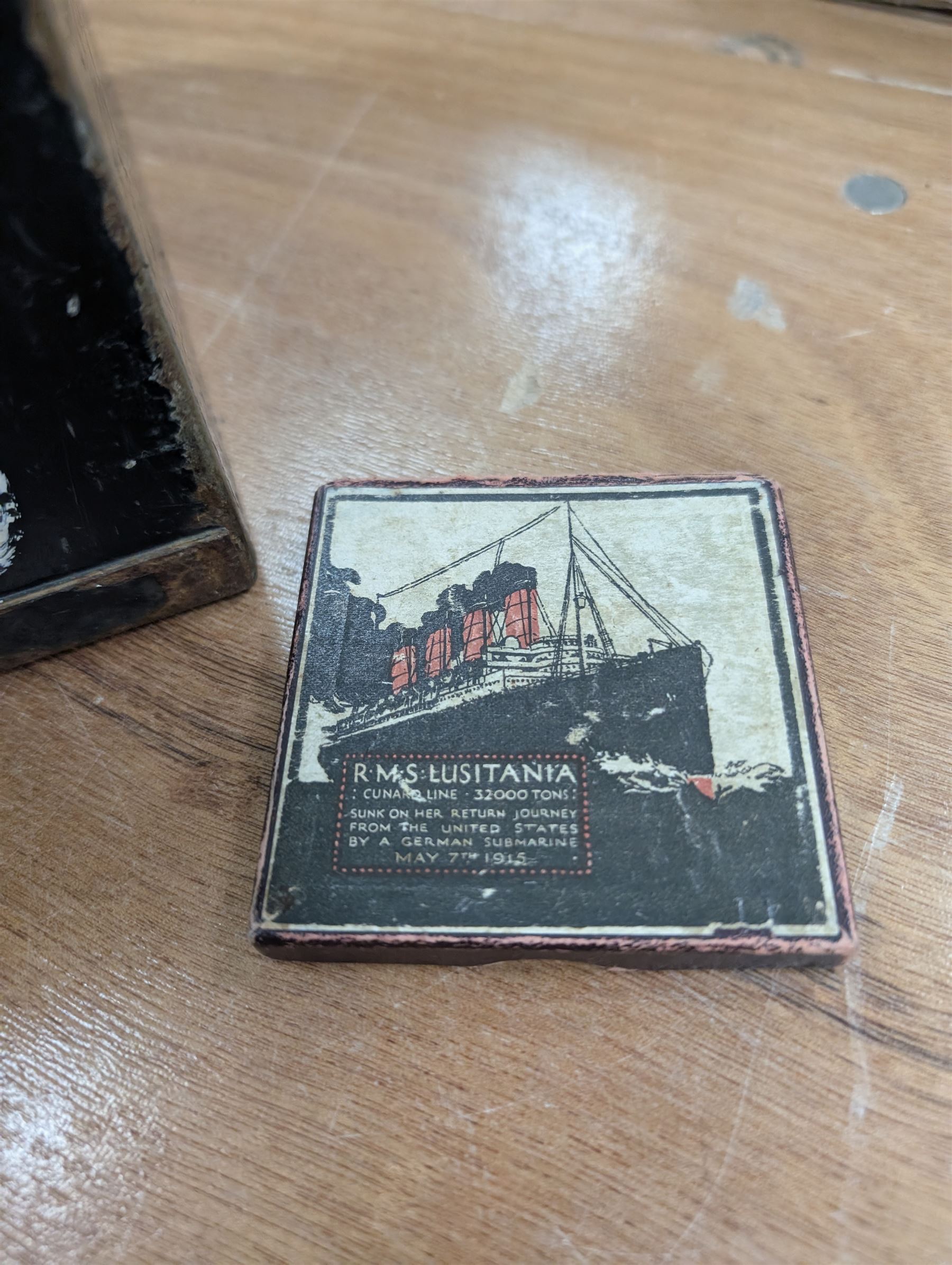 WWI brass shell case, by vendor repute salvaged from SS Cadmus wreckage site June 2007 off Flamborough Head, together with a reproduction RMS Lusitania medal in box and a metal tin