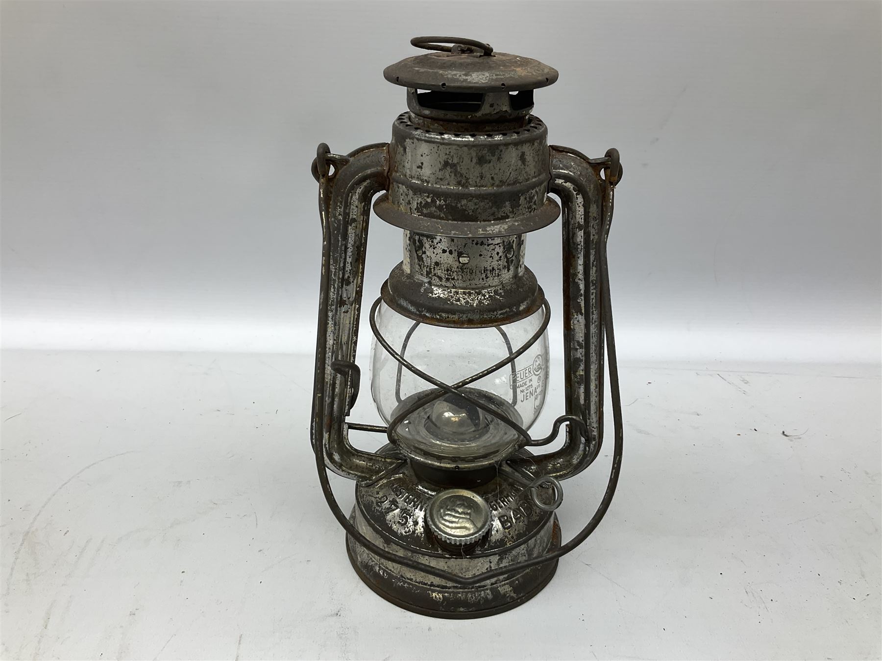 Copper and brass ship’s lamp marked ‘Anchor’, H25cm, Feuer hand storm lantern, Bialaddin Model 315 paraffin lamp and an Anchor lamp (4)