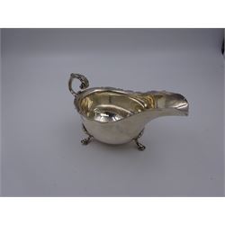 Early 20th century silver sauce boat, of typical form with shaped rim and acanthus capped flying C scroll handle, upon three palmette mounted hoof feet, hallmarked Thomas Edward Atkins, Birmingham 1915, including handle H8.5cm