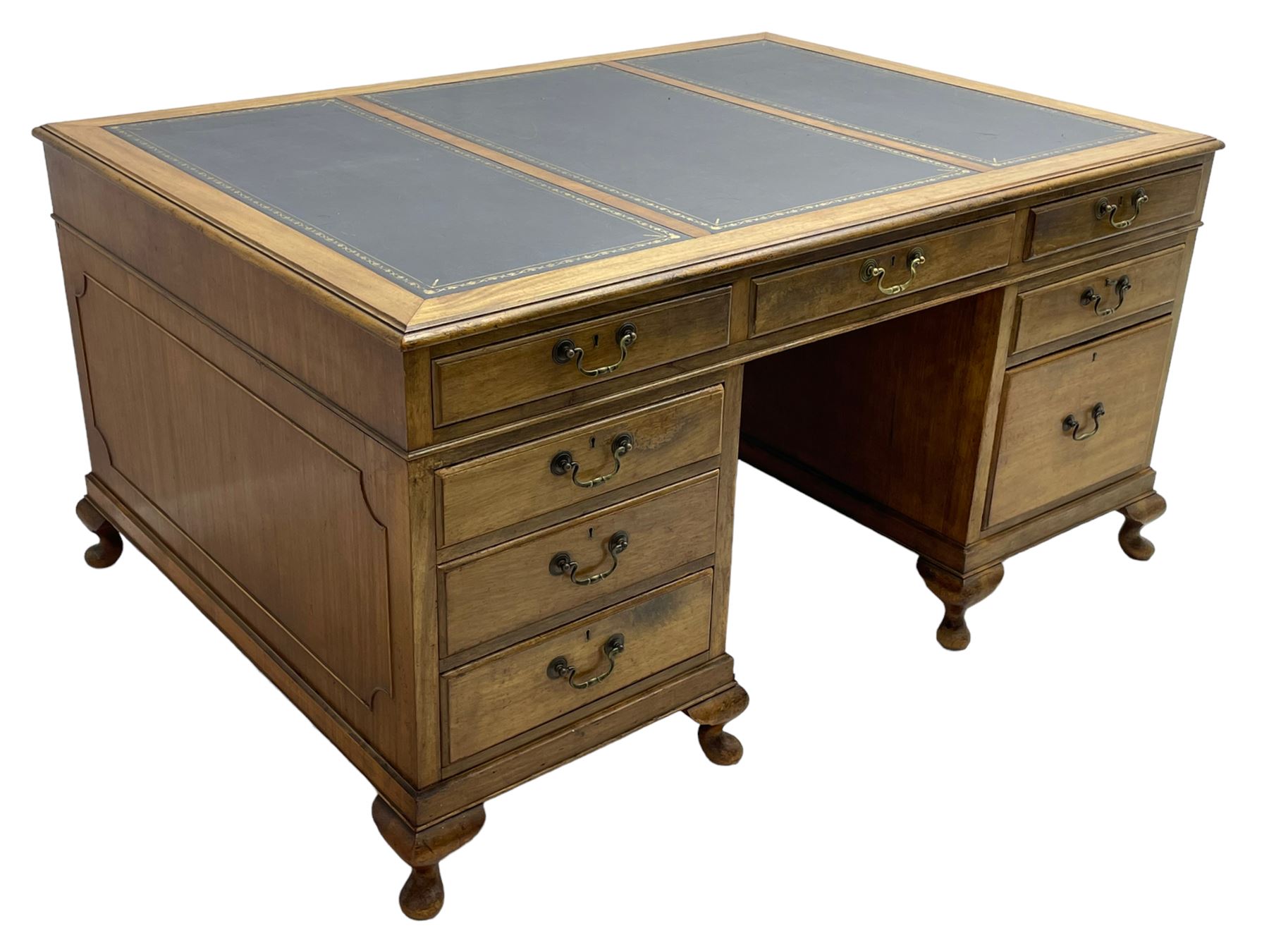 Early 20th century mahogany twin pedestal desk, the moulded rectangular top with three sectional leather insets with gilt decoration, fitted with eight drawers, on cabriole feet