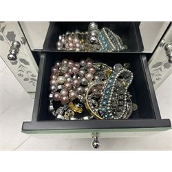 Large collection of costume jewellery including beaded necklaces, earrings, pendant necklaces, rings and wristwatches in glass mounted four drawer jewellery chest