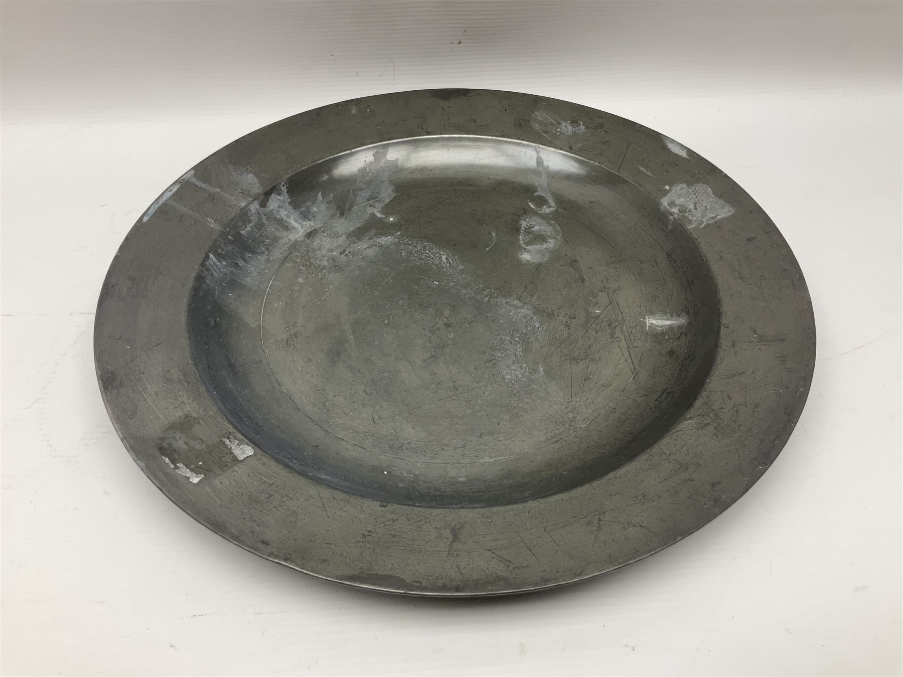 Group of seven 19th century pewter chargers, each of circular form with dished centre, two examples with touch marks verso, each approximately D39cm