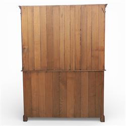 Georgian style oak dresser, the moulded cornice above two open plate racks, upon base with rectangular top above an arrangement of three frieze drawers fitted with brass swan neck handles, and three panelled cupboard doors, upon bracket feet