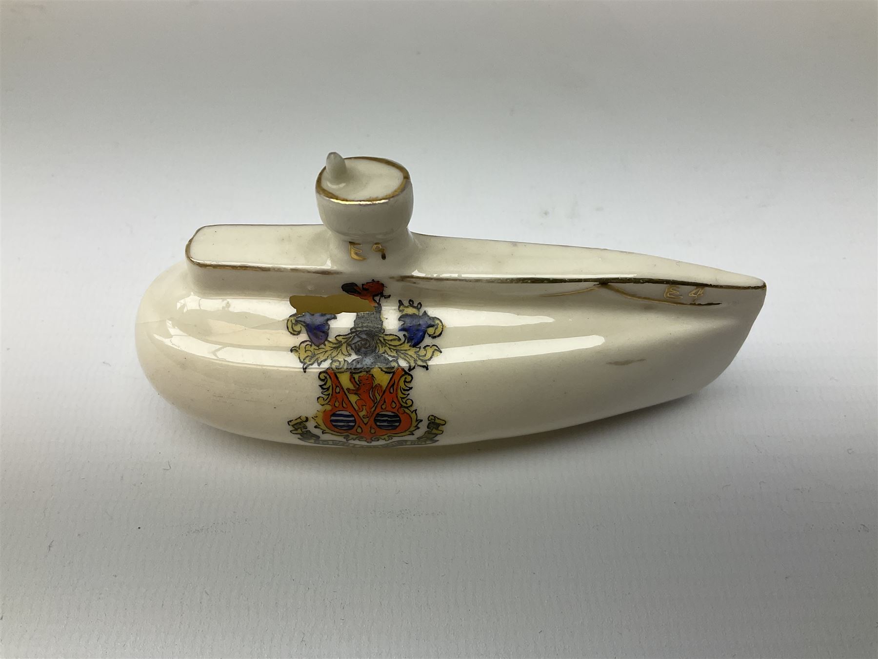 Three pieces of crested ware, comprising grenade detailed 'The Mills Hand Grenade' with Filey Crest, marked beneath Grafton China, a cannon with crest banner detailed 'Sterlini Oppidvm', marked beneath W H Goss, and a submarine with Tunbridge Wells crest, marked beneath Arcadian China 