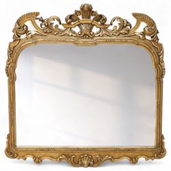 Georgian design giltwood overmantel mirror, arched rectangular plate within a moulded frame, the cresting carved with scrolling acanthus and shell motifs, trailing foliate decoration continuing to the shoulders and lower apron