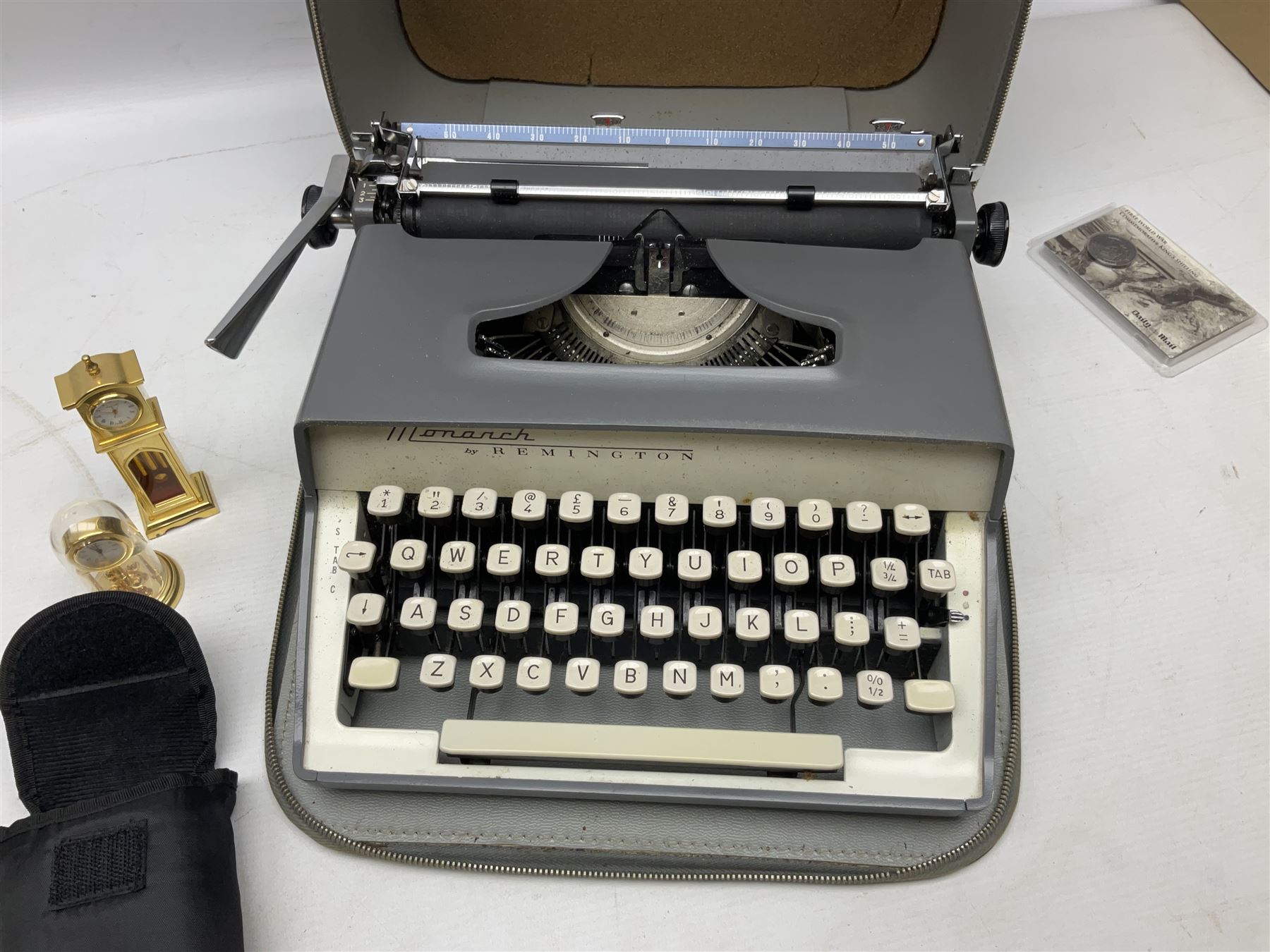 Kundo quartz clock, miniature brass clocks, two barometers, Sony digital camera, Nokia phone, Monarch Remington typewriter, commemorative Shilling etc