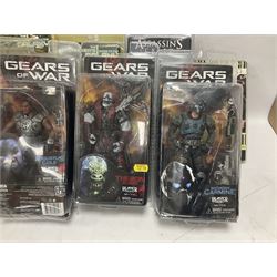 Sixteen carded action figures comprising seven 'Gears of War'; four 'Hitchhikers Guide to the Galaxy'; two 'Torchwood'; 'Planet of the Apes'; 'Bruce Lee'; and 'Assassin's Creed'; all in unopened packs (16)