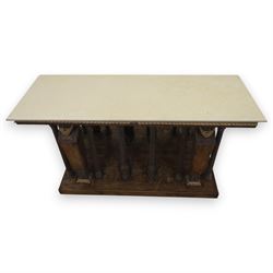 20th century carved hardwood console table in Renaissance taste, moulded marble slab top over a frieze decorated with festoons and roundels, the angles carved with grotesque mask brackets, supported by six fluted columns with carved mask and paw feet terminals, on a stepped plinth base with mirrored back