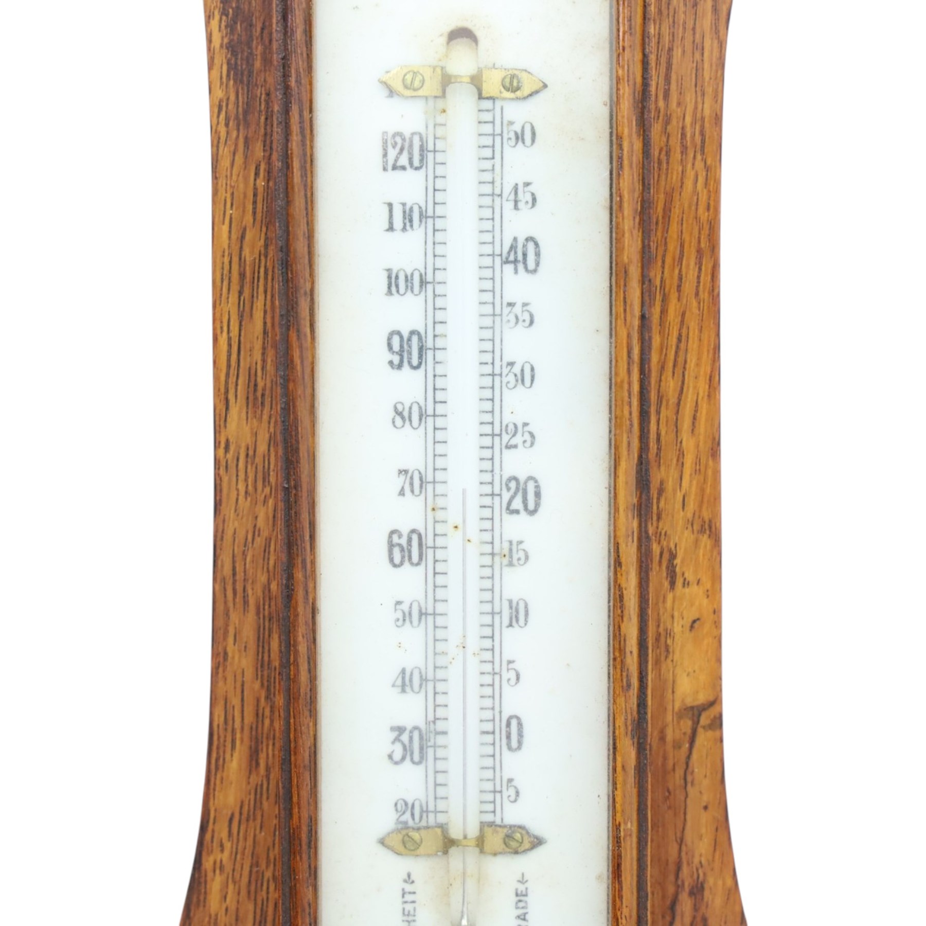 Late Victorian carved oak aneroid barometer, the foliate crest above a glazed thermometer and circular dial, with further carved decoration below, H 75cm