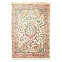 Fine Persian silk inlaid ivory and rose ground Tabriz rug, the busy field decorated with a...