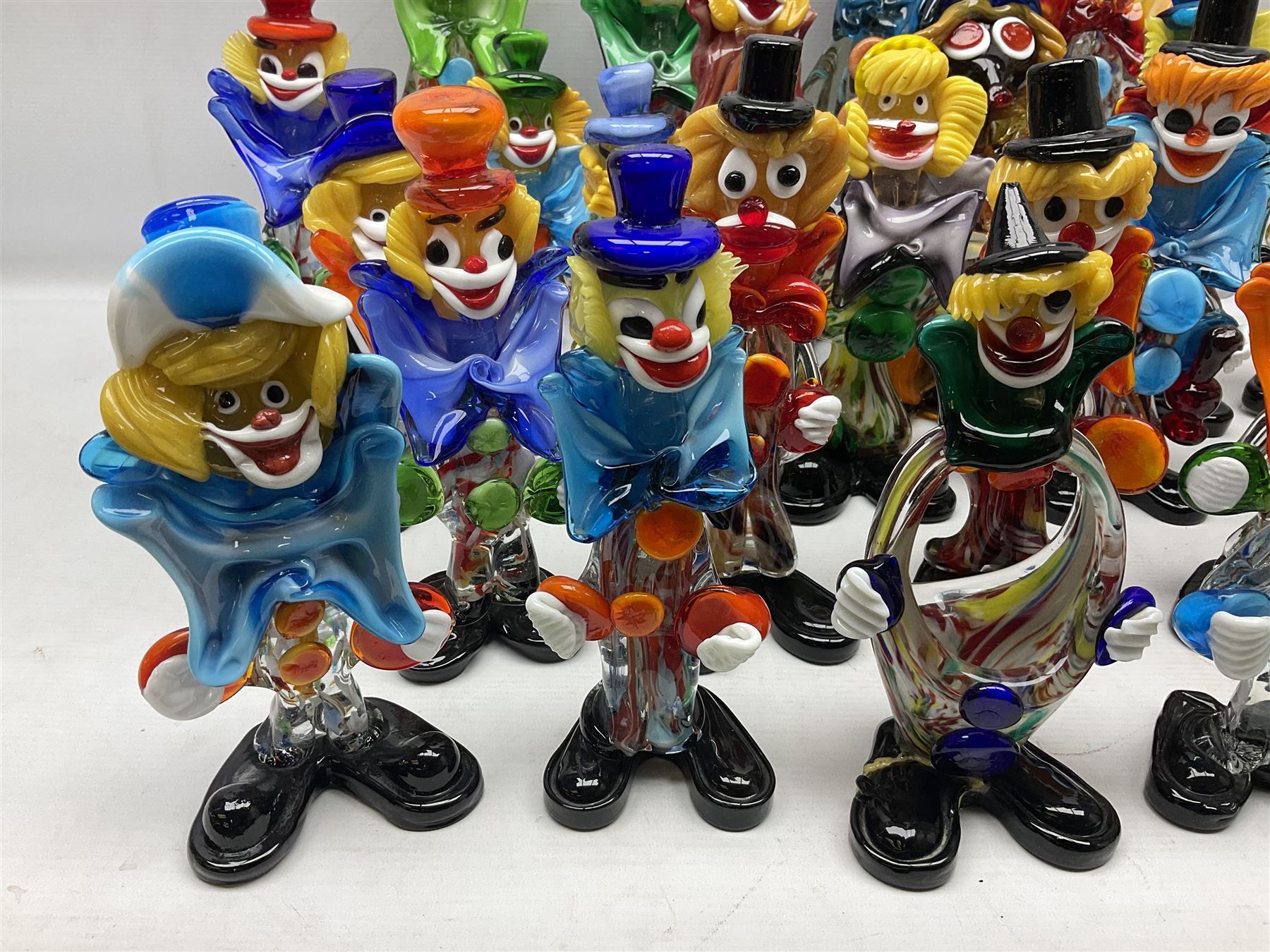 Large quantity of Murano glass clowns, to include larger examples, in two boxes