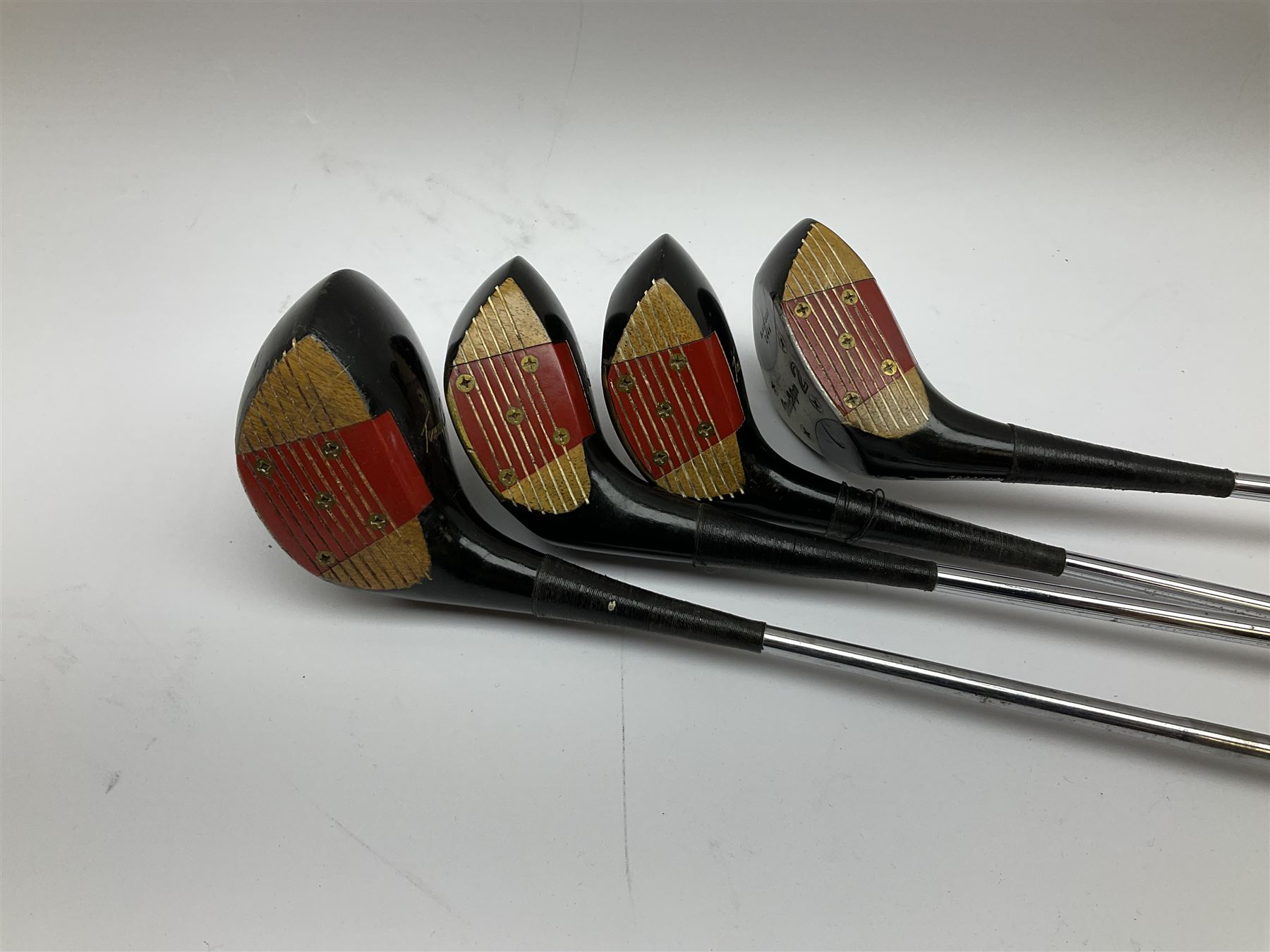 Golf - three early 20th century hickory shafted irons marked R. Simpson, Harrods Ltd etc; child's wooden shafted putter; two transitional wood grain steel shafted irons, one marked Tom Morris; and set of four Macgregor Tommy Armour woods (10)