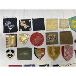 Approximately one-hundred printed and embroidered cloth badges including Royal Tank Regiment, Royal Armoured Corps, 219th Independent Infantry Brigade, Cyrenaica, Cyprus, Singapore and other districts, Gibraltar Garrison, East Anglian Brigade, 20th Armoured Brigade and various armoured divisions etc