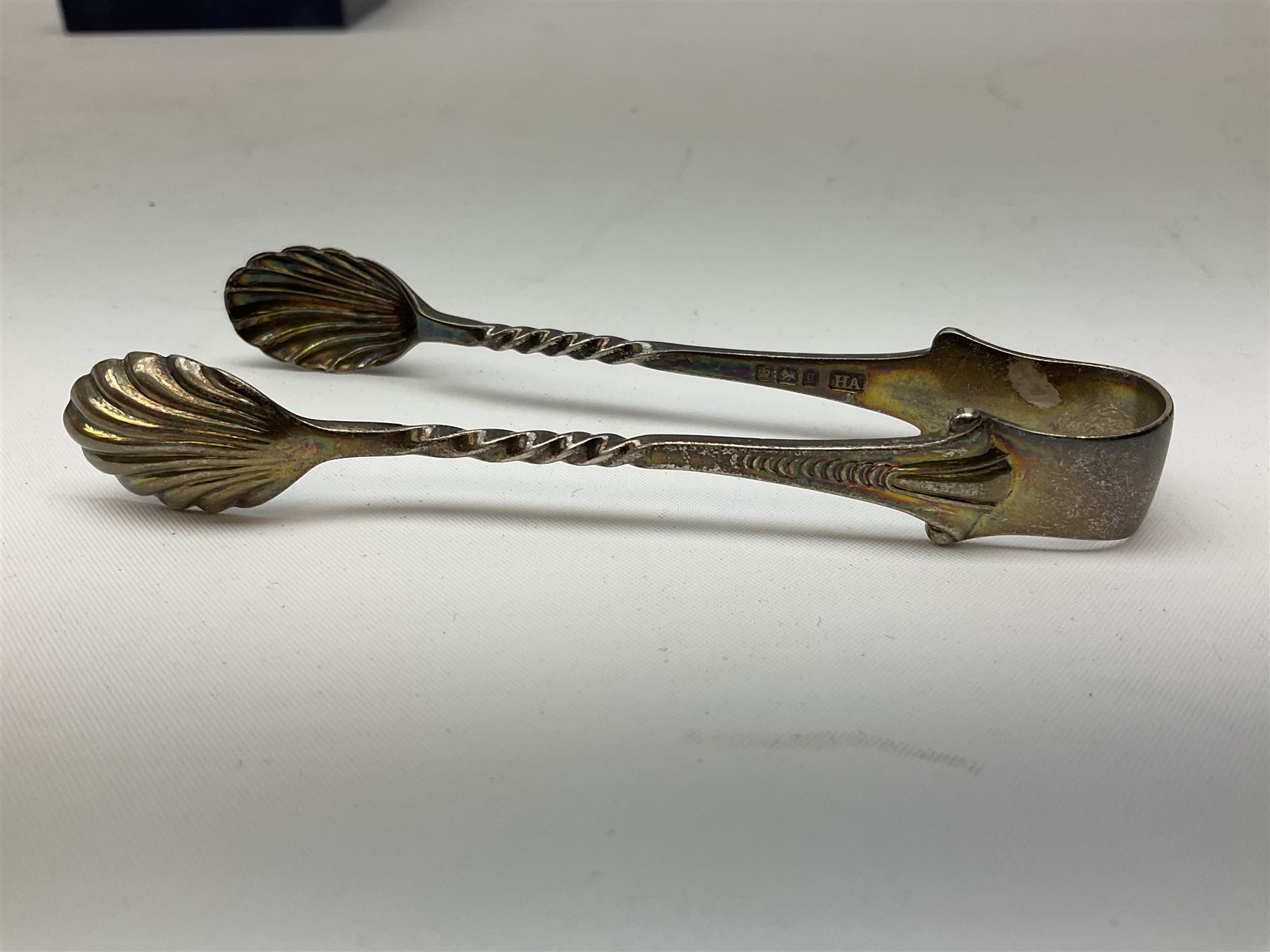 Pair of miniature hallmarked silver cruets, in fitted box, together with a pair of hallmarked silver sugar tongs, approximate total silver weight 38 grams