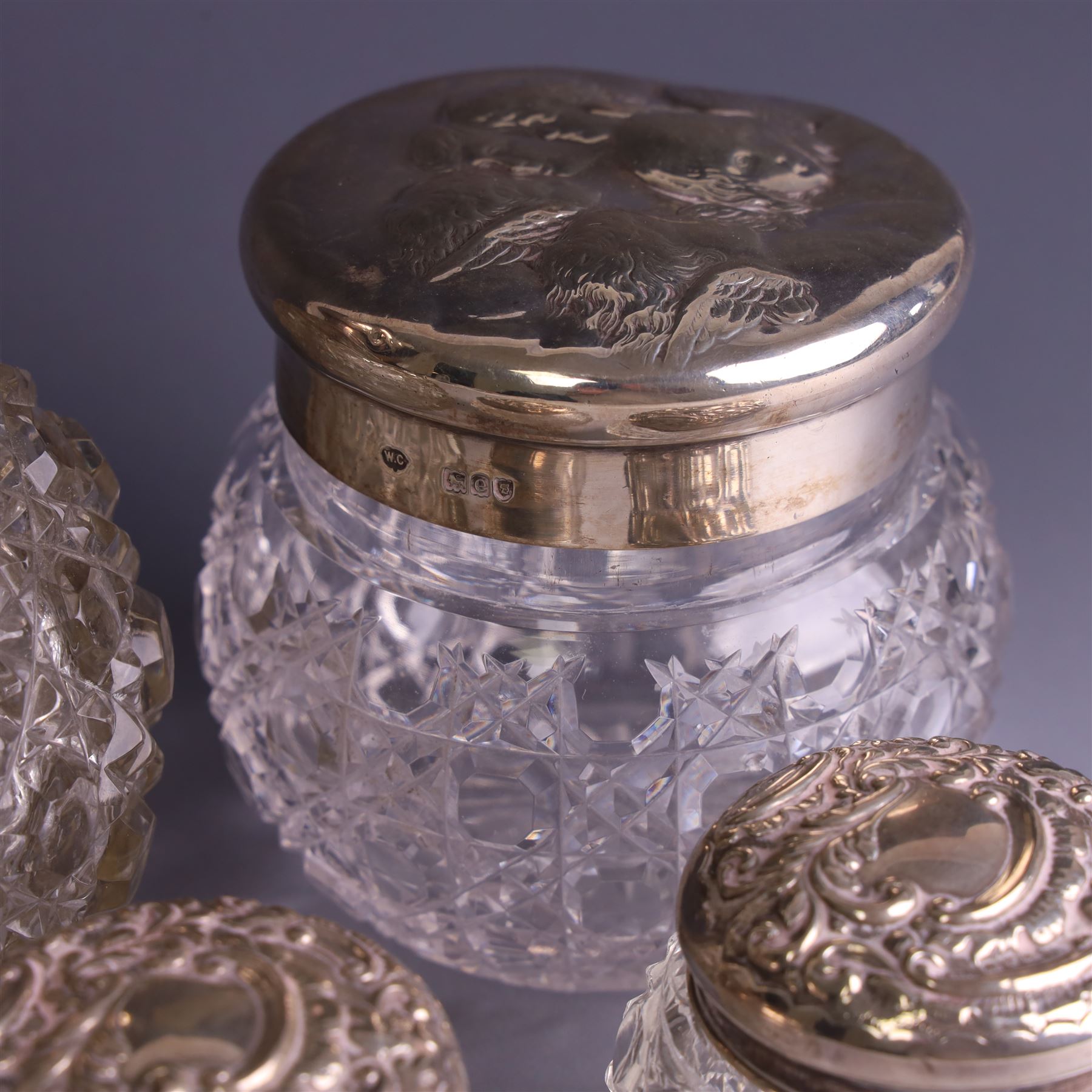 Early 20th century silver mounted cut glass scent bottle, with silver lid and three cut glass dressing table jars with silver lids, all hallmarked 