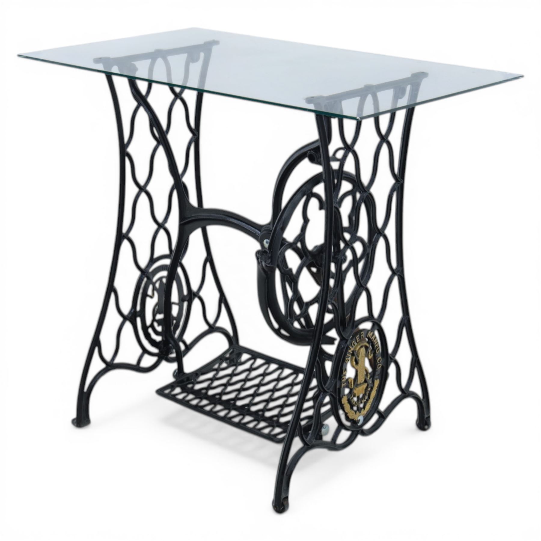 Sewing machine table with glass top, with Singer wrought metal base and foot pedal